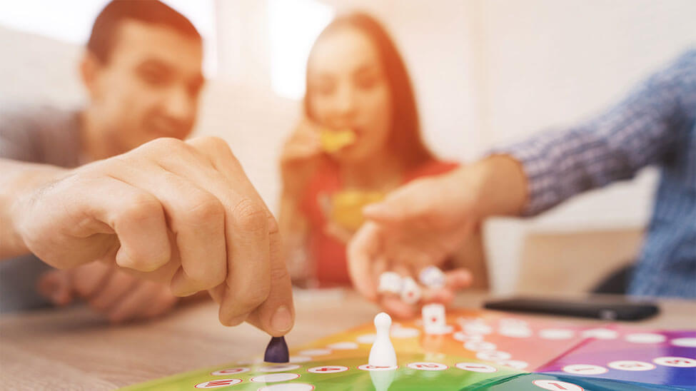 Family plays board game during shared family time