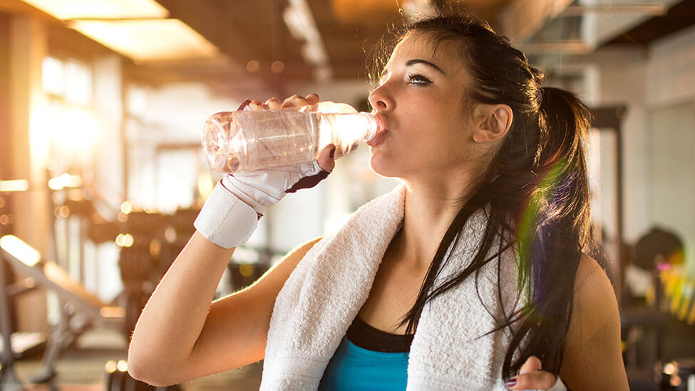 Woman drinking from plastic bottle