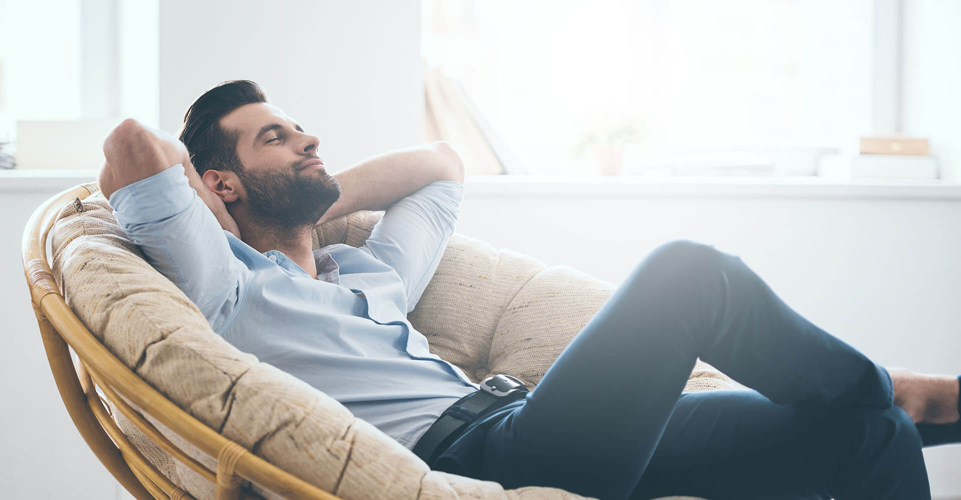 Man relaxes casually in armchair