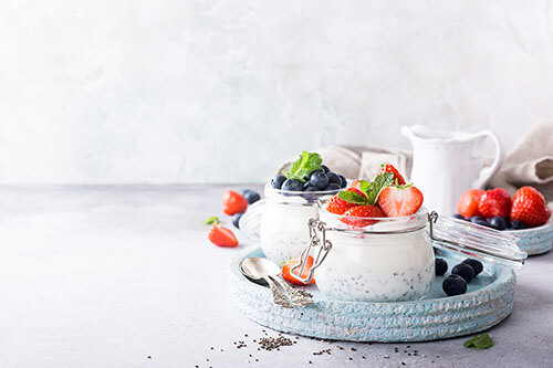 Various superfoods like berries, strawberries and chia seeds together with cottage cheese