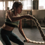Woman performs the Crossfit exercise rope swings