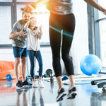 Child doing CrossFit exercises with his parents