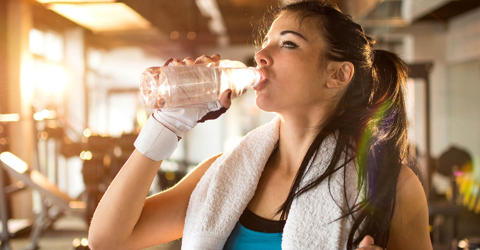 Woman drinks water during training