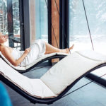 Woman relaxing in towel after sauna session on a lounger