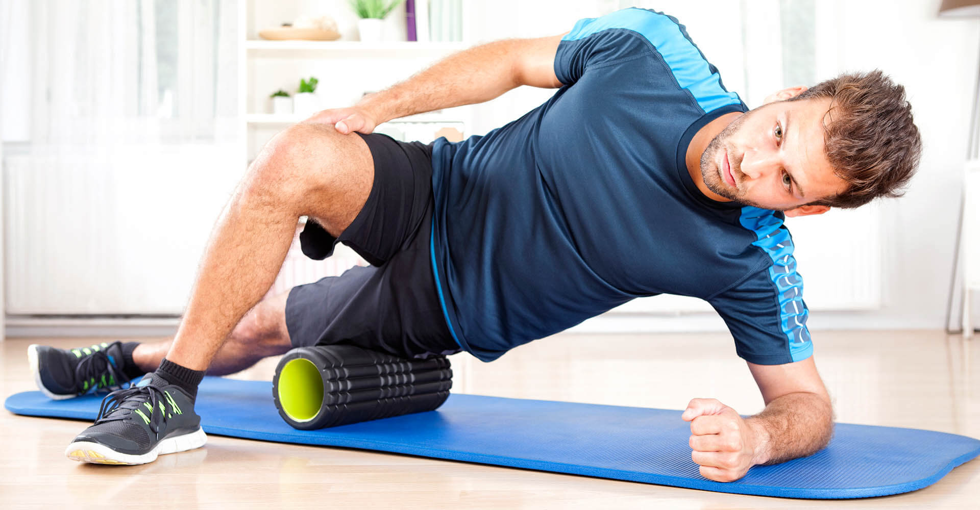 Man trains at home on isomat and fascia roller