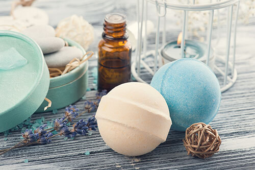 Several wellness utensils like bath balls, oil and candles