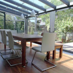 Winter garden with sliding elements as doors and furniture
