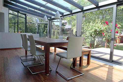Winter garden with sliding elements as doors and furniture