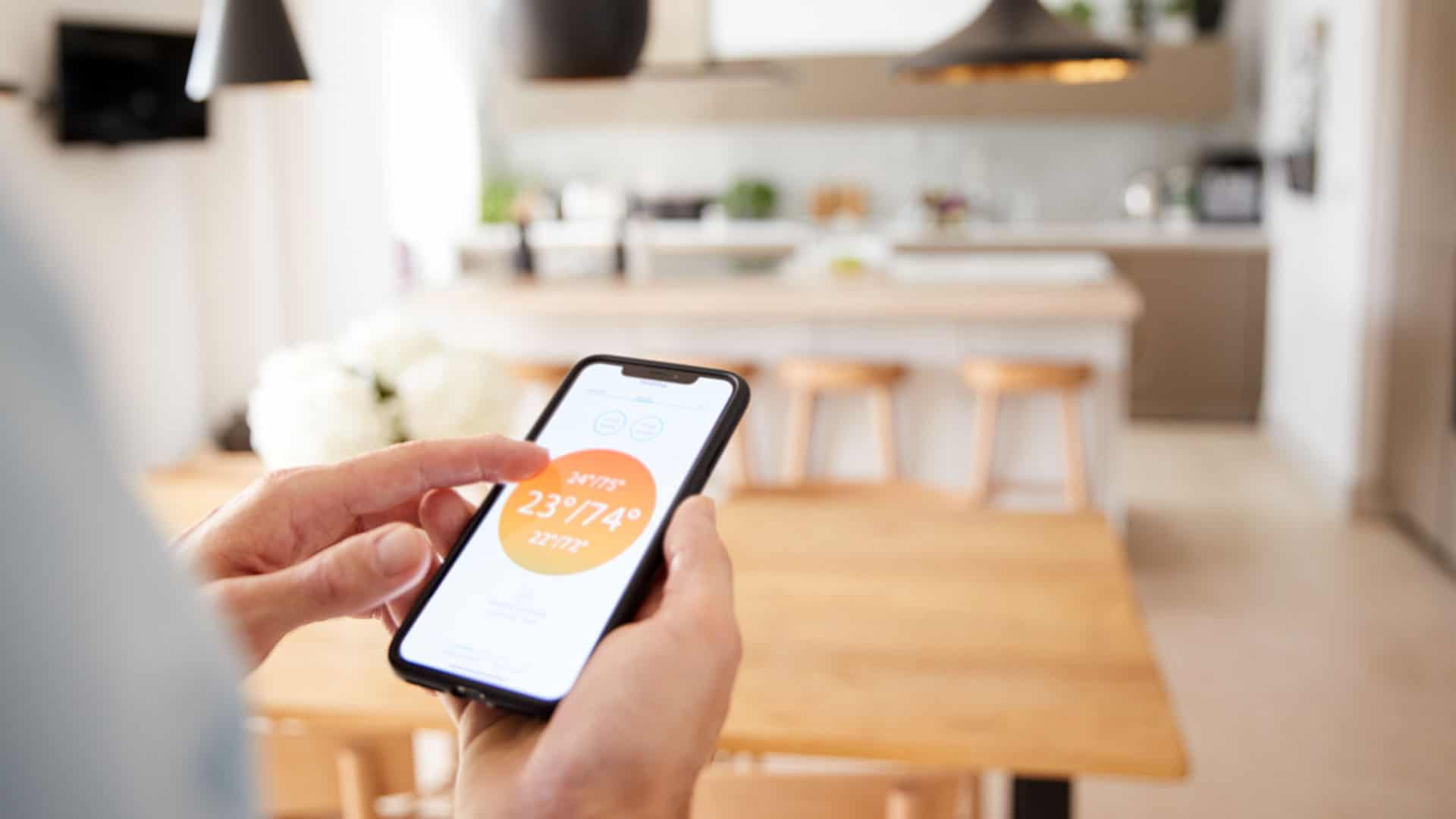 Woman with smartphone on Smart Home heater