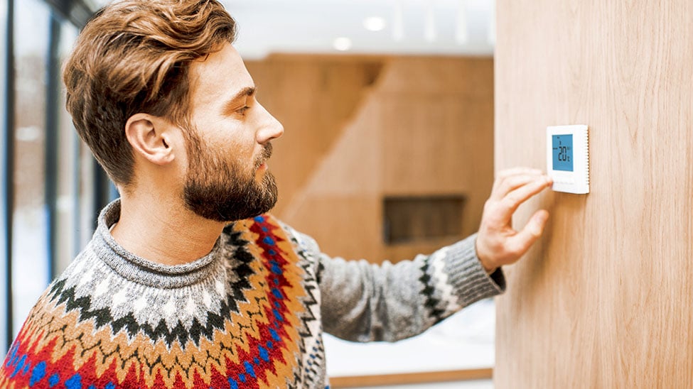 Man adjusts smart home heater