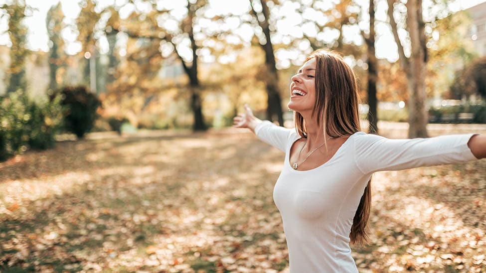 Woman doing breathing exercises outdoors