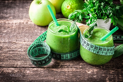 Diet shake from apples with tape measure around it