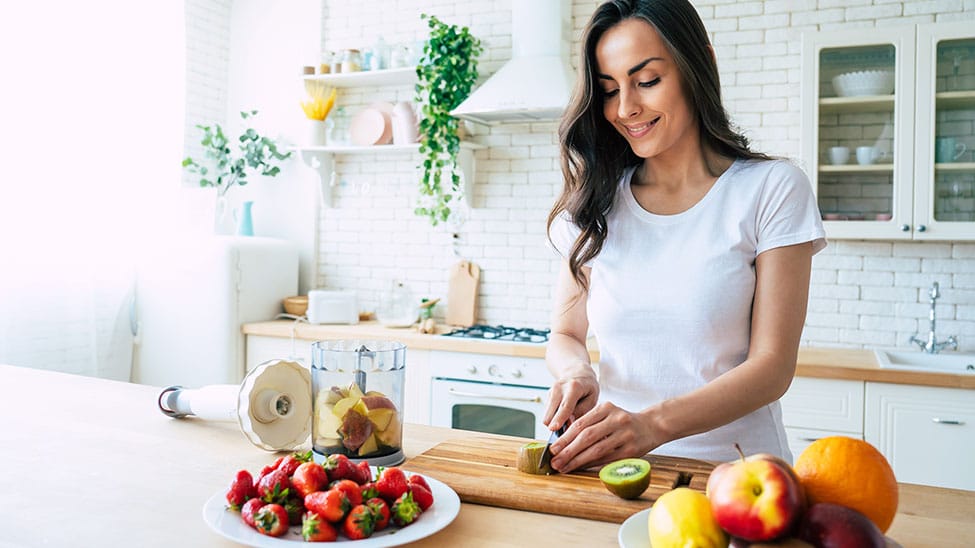 Woman prepares fruit to strengthen her immune system