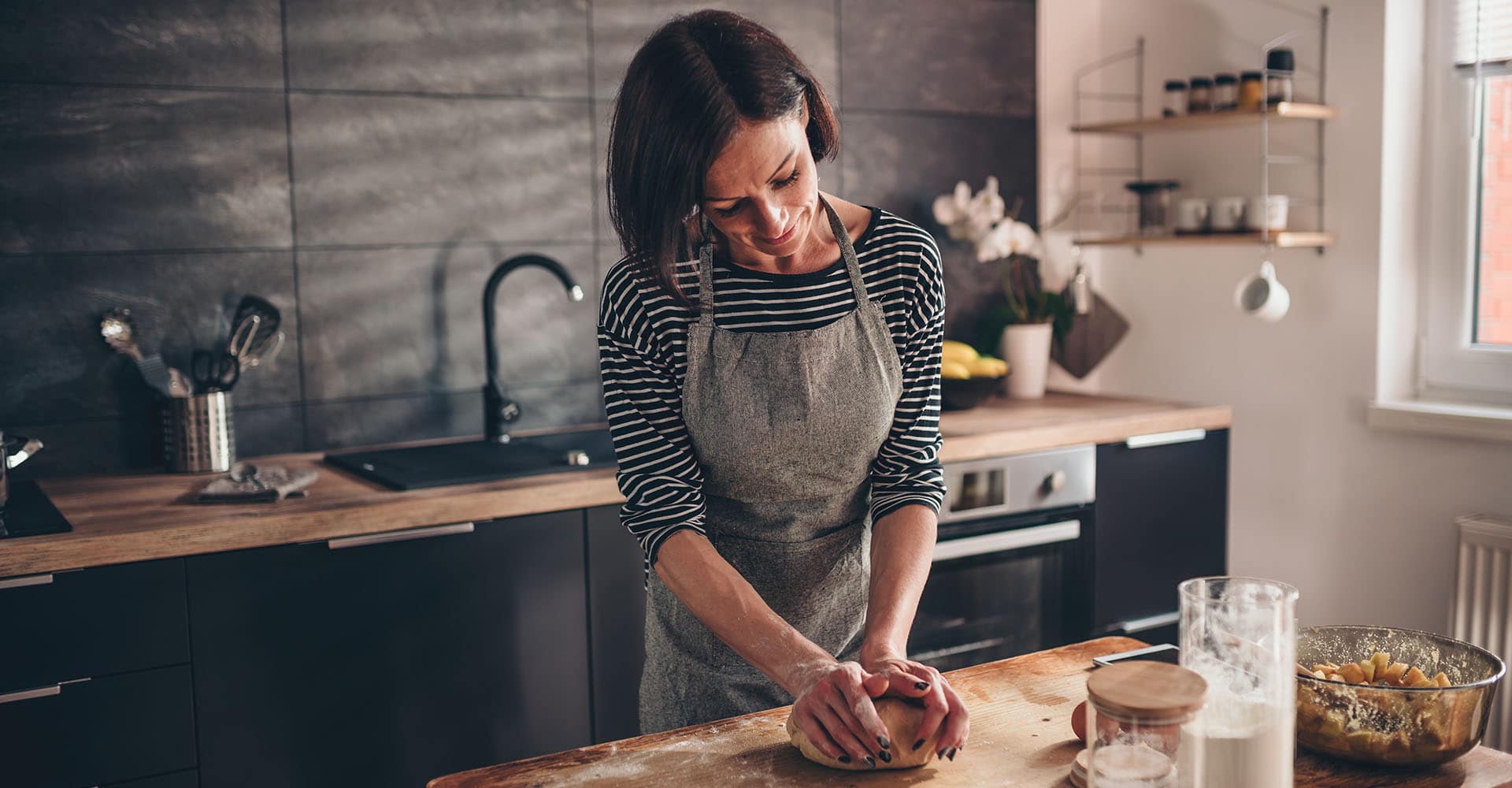 Woman baking bread in kitchen